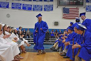 Doug Simmons does a little dance down the aisle after receiving his diploma. Photo by Beth David.