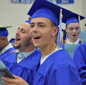 L-R: Jahi Lomba (head down), Nathan Lopes and Tyler Lopes sing with gusto at Fairhaven High School’s graduation on Sunday, 6/5.Photo by Beth David.