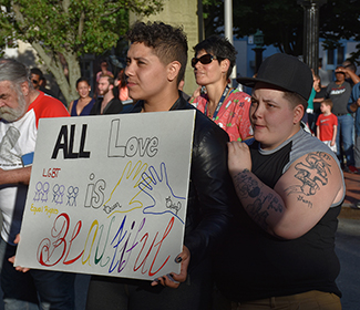 L-R; Jadahcis Howard and Nicole Pendergast with sign that says “All Love is Beautiful” at the vigil in front of New Bedford City Hall on 6/14/16. Photo by Beth David.