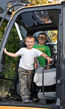 L-R: Brayden (white shirt) and Bryce in the cab of a bucket loader at National Night Out in Acushnet on 8/2/16.